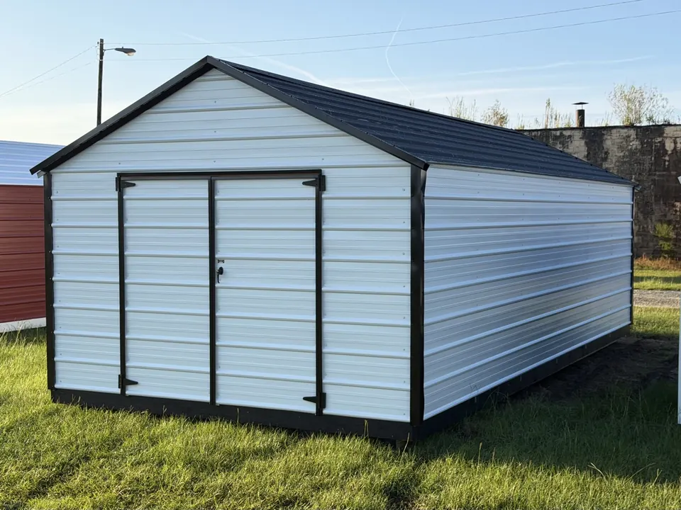 White horizontal-ribbed metal economy shed with black trim and black metal roof