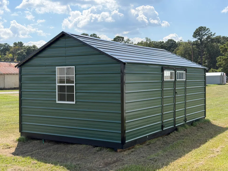 Green metal economy shed with black trim and double doors with transom windows